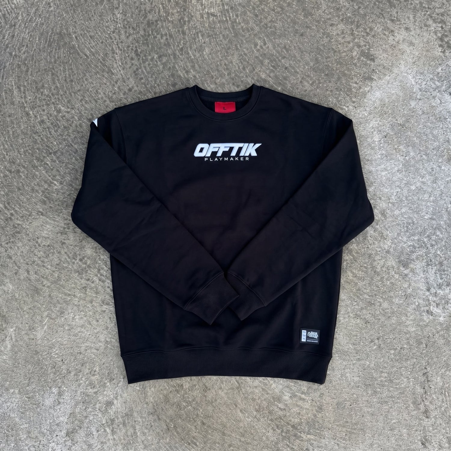 Black sweatshirt with 'OFFTIK' logo on a gray surface
