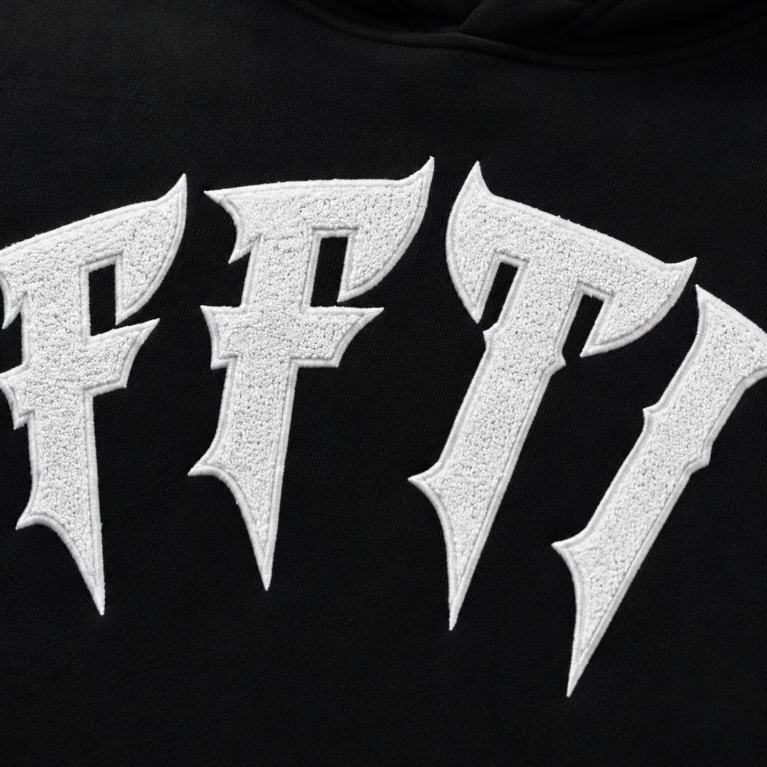 Close-up of a black hoodie with metallic 'FF7' logo.