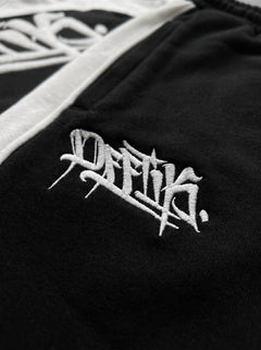 Black jacket with white embroidered logo on a black background