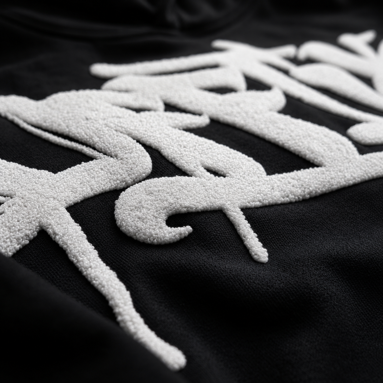 Textured white designs on a black background