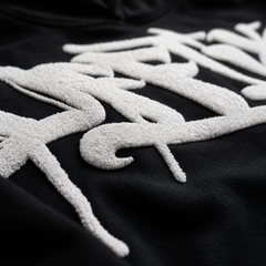 Textured white designs on a black background