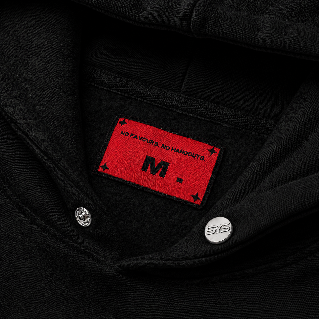 Black jacket with a red patch featuring text and a logo on the chest.