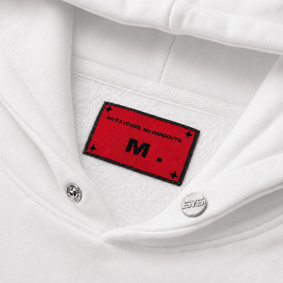 Close-up of a white shirt with a red label featuring text and a logo., image 5