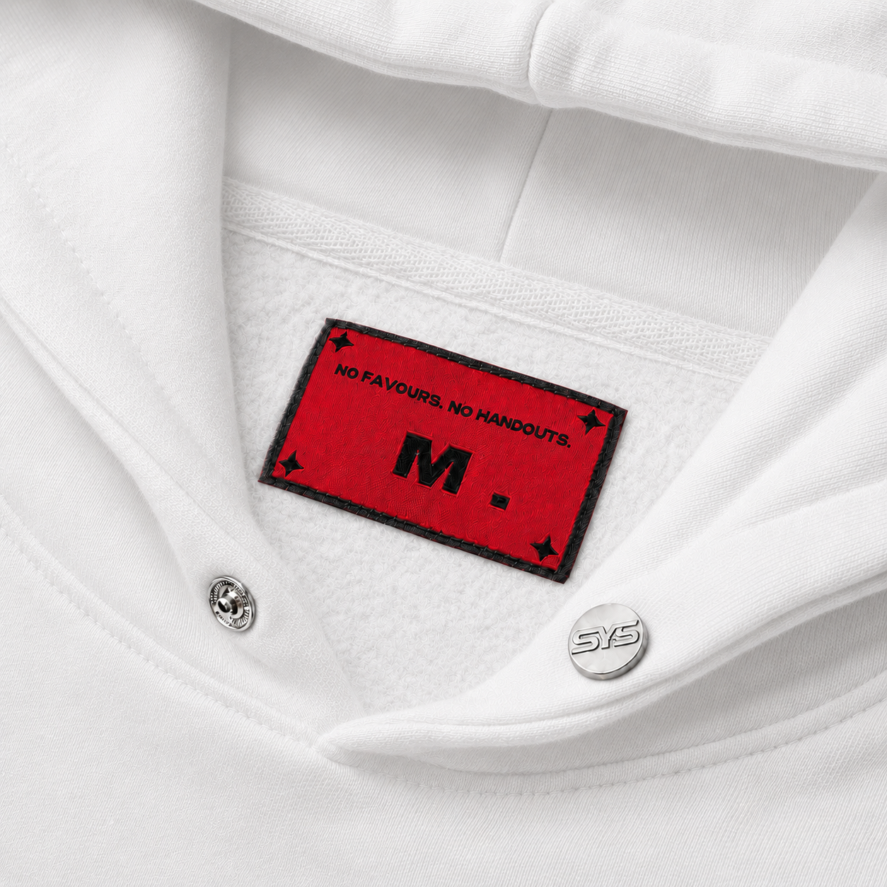 Close-up of a white shirt with a red label featuring text and a logo.