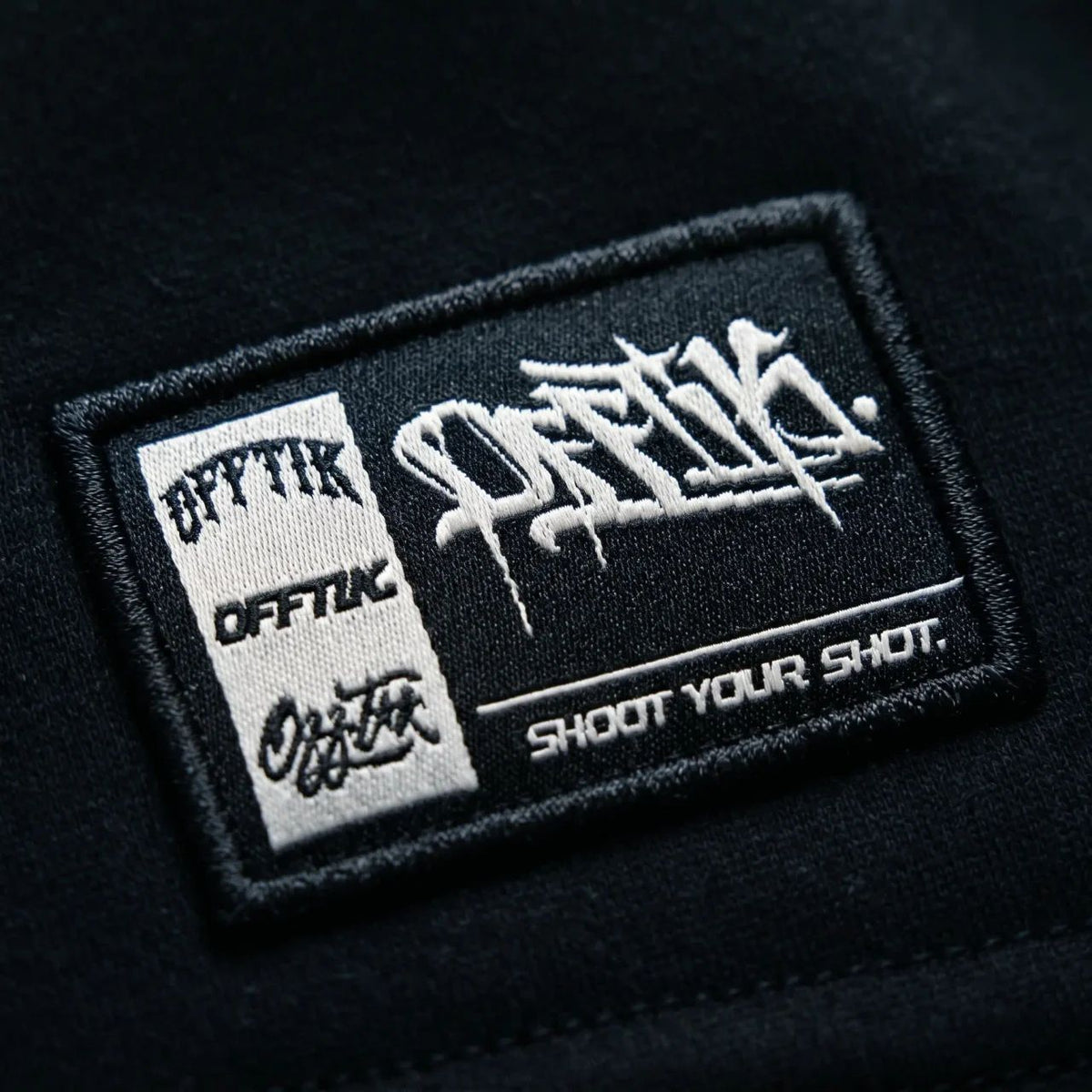 Black patch with white text and branding on a black background, image 5
